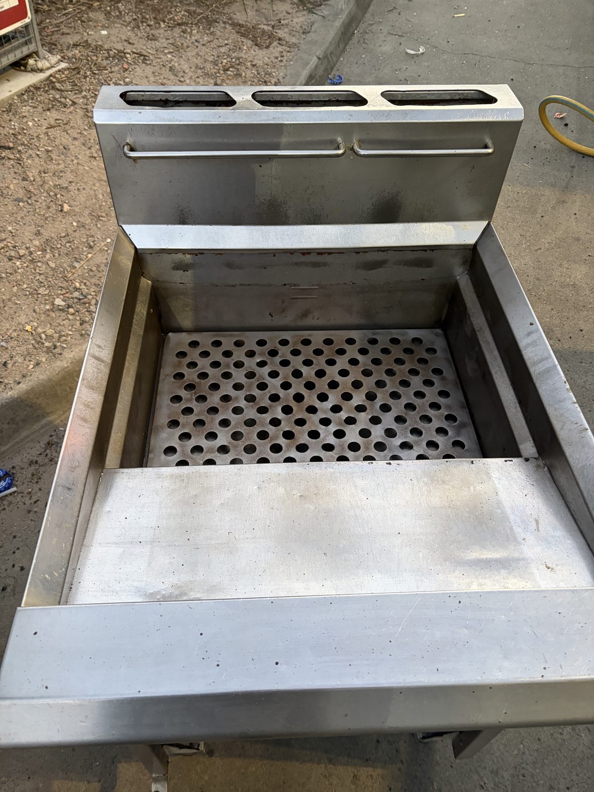 Backsplash and perforated crumb screen — rust and baked residue off — after dry ice cleaning
