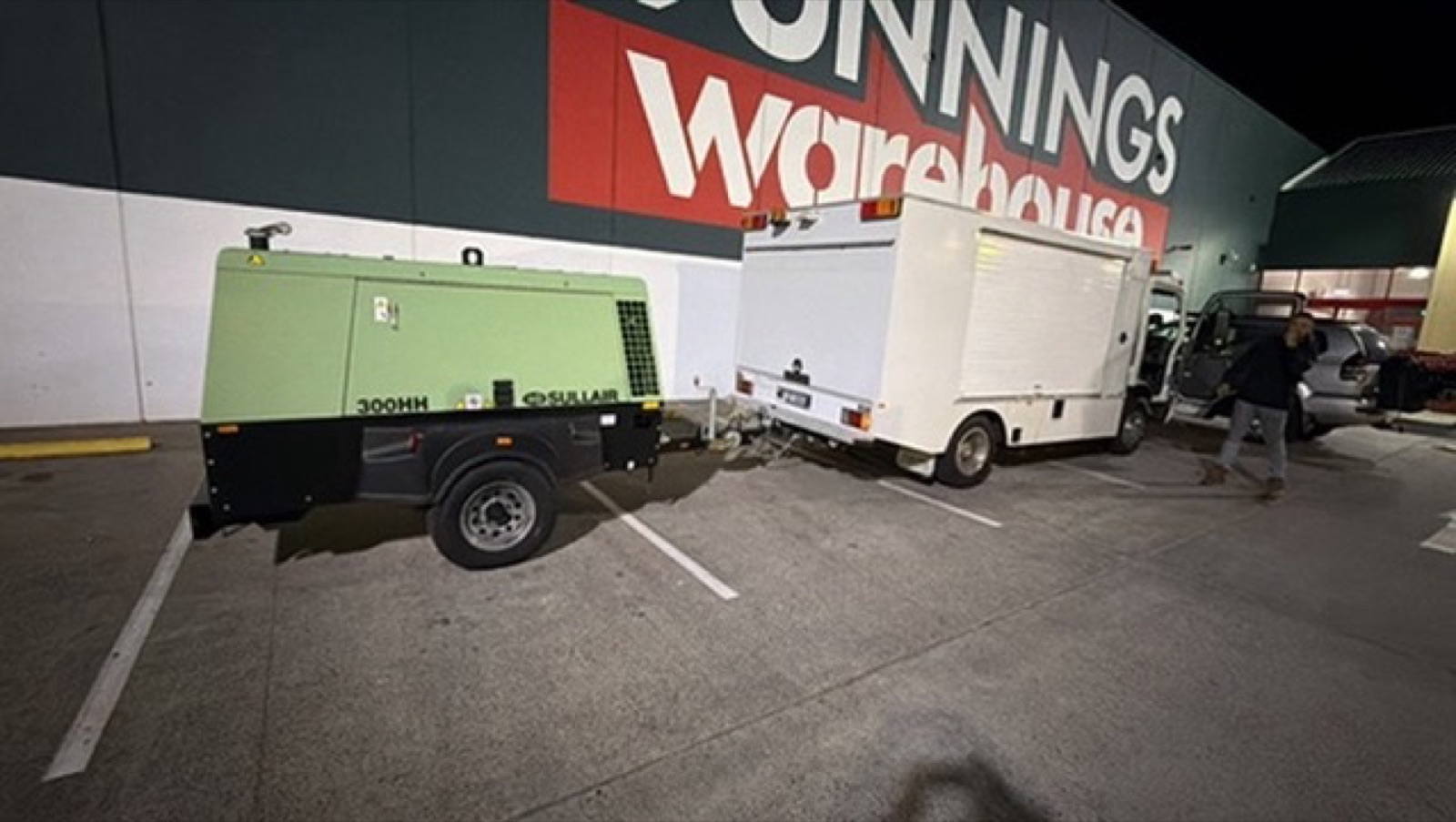 Dry Ice Blasters box truck and Sullair 300HH compressor trailer parked at night